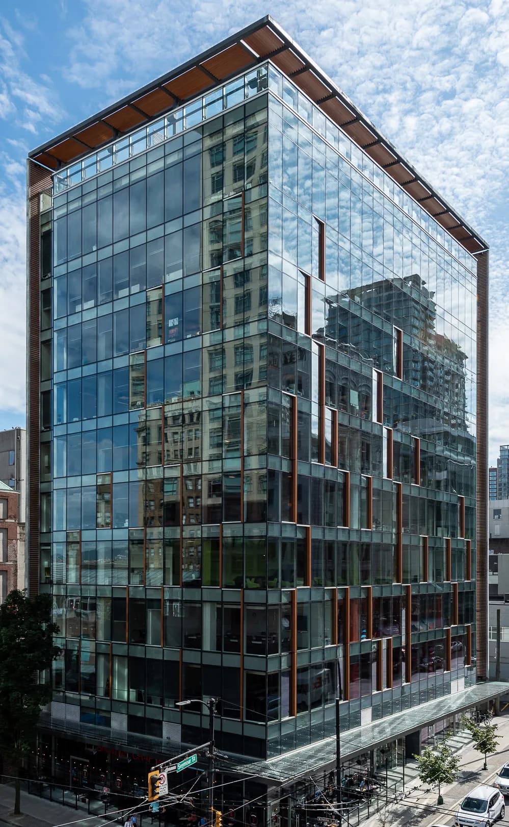 Multi-storey glass curtain wall commercial office building on urban street corner