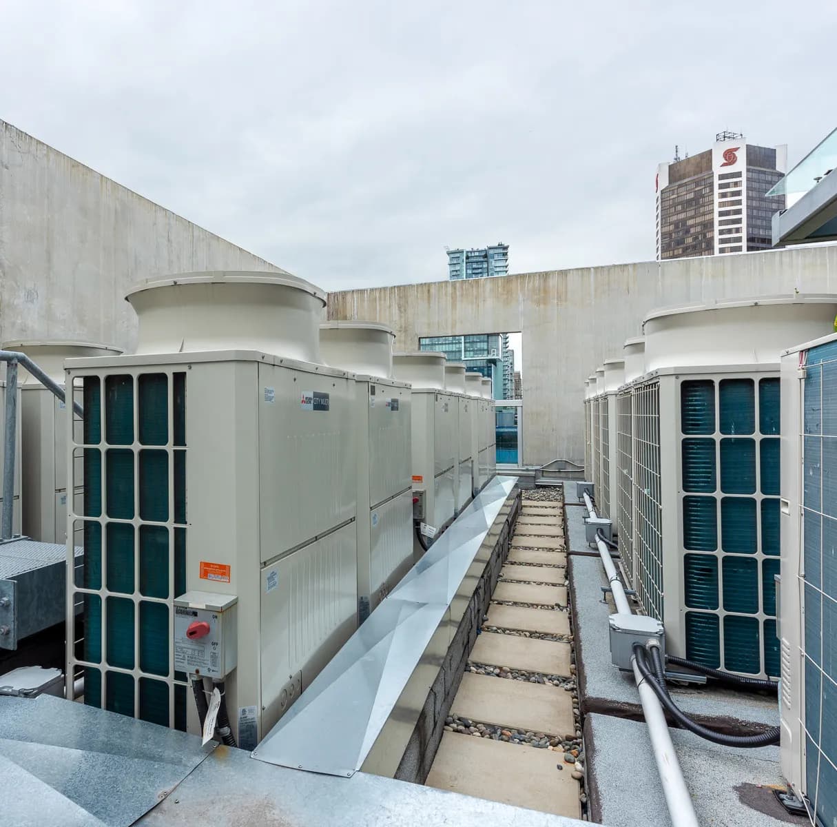 Mitsubishi City Multi VRF rooftop condensing units installed in rows on commercial building